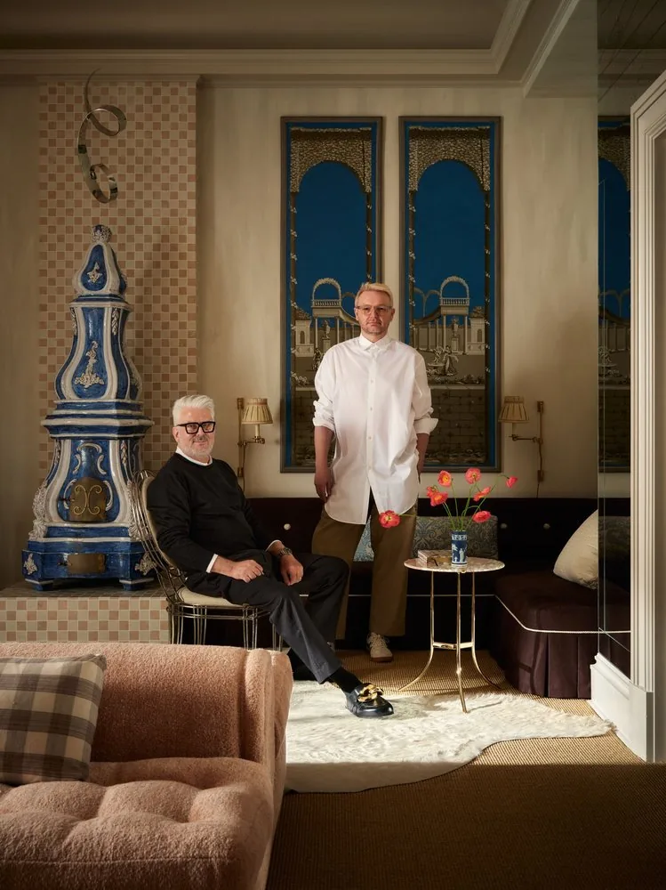 Mark and Mikal Eckström pictured with the kachelofen and Zuber panels in their Kips Bay room