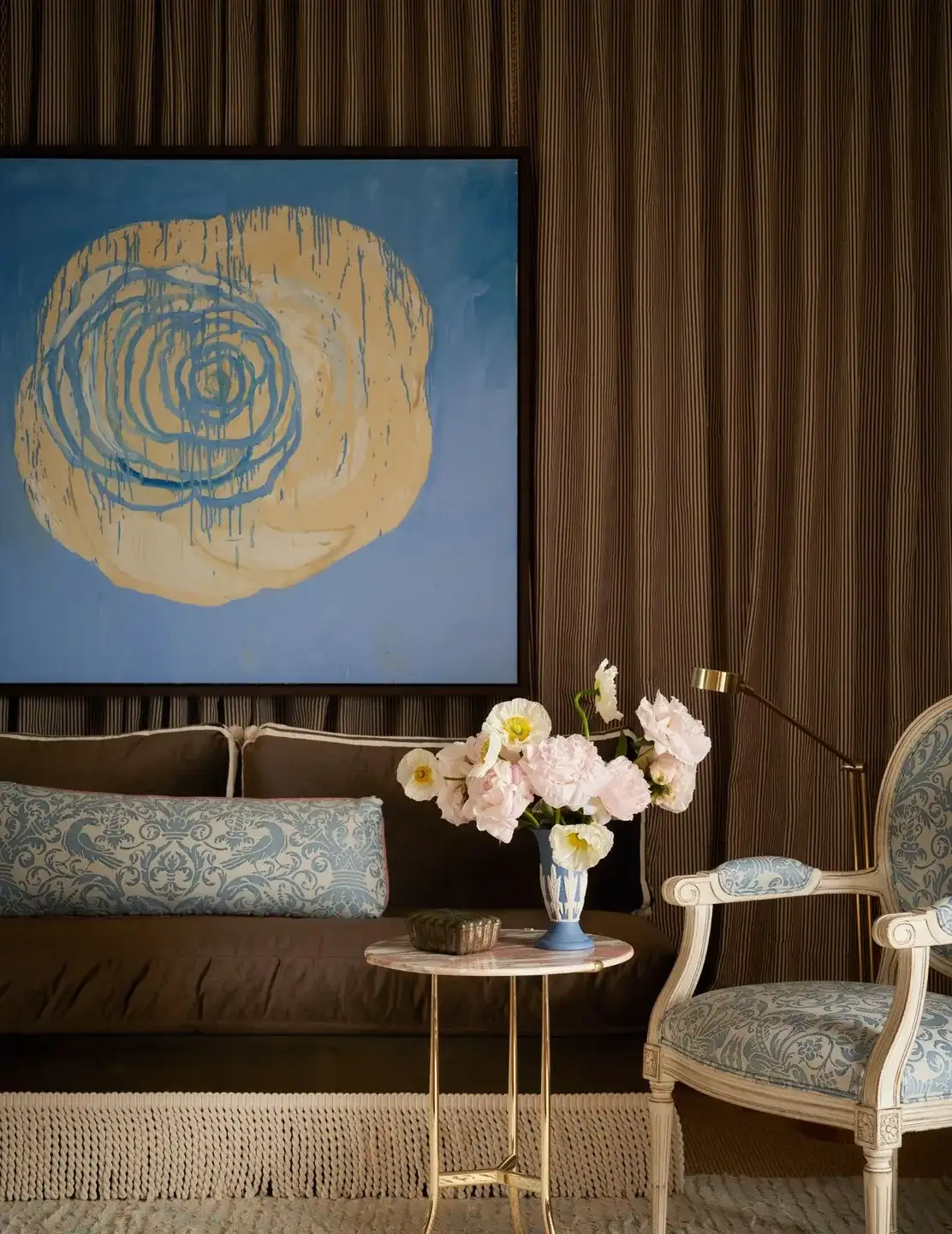 An abstract rose painting hangs above the chocolate velvet sofa in Mr. Trotter's Drawing Room